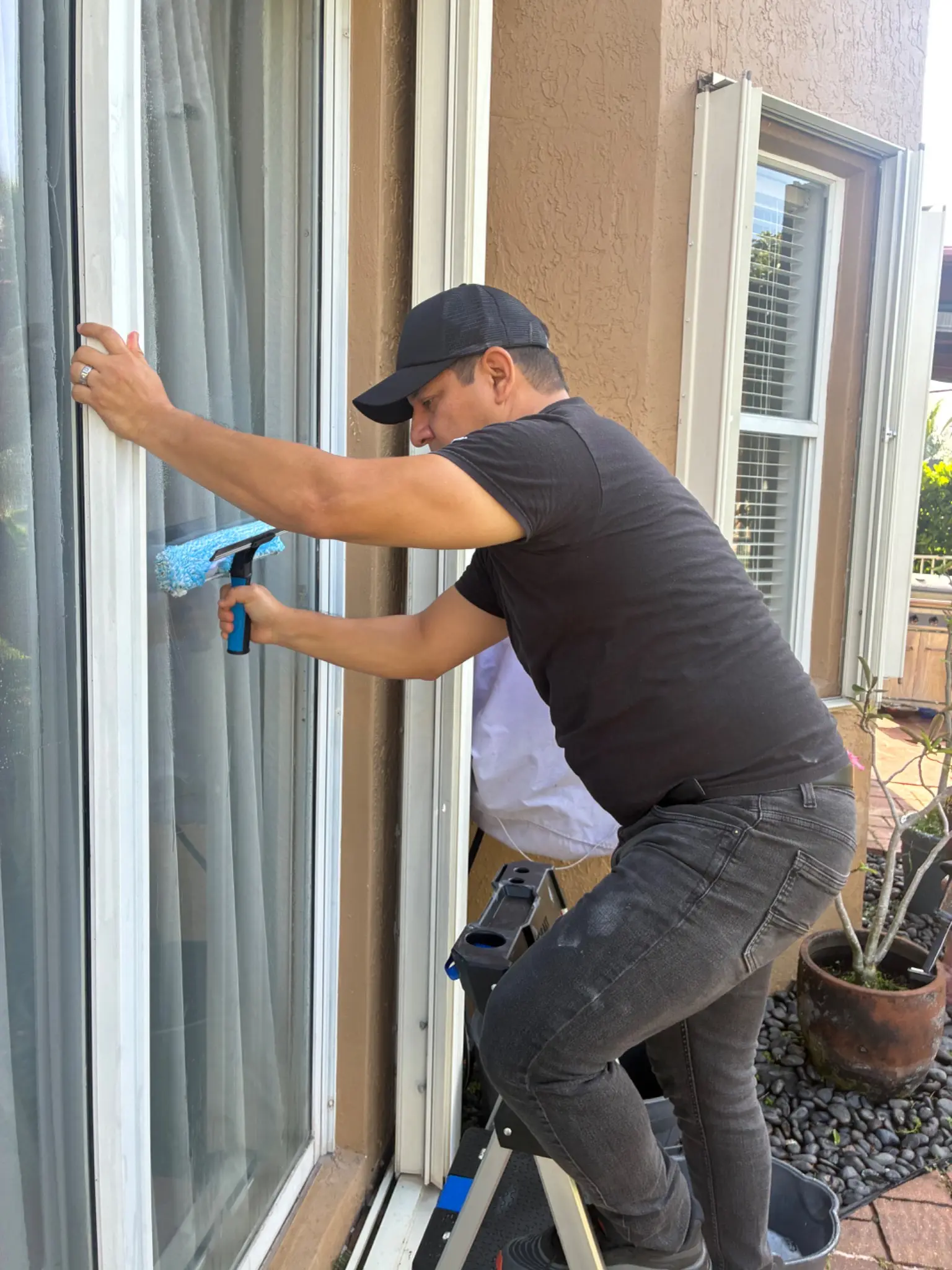 ReadyHandoff Cleaning team member cleaning a window